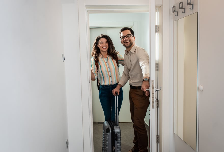 smiling-couple-with-suitcase-arriving-in-hotel-roo-2025-01-29-12-49-26-utc